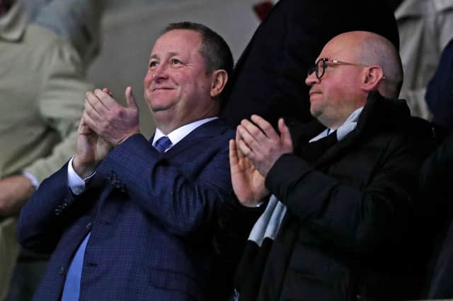 Newcastle United’s English owner Mike Ashley (L) and director Lee Charnley (R) applaud after Newcastle take the lead during the FA Cup fourth round replay football match between Oxford United and Newcastle United at the Kassam Stadium in Oxford, west of London, on February 4, 2020.