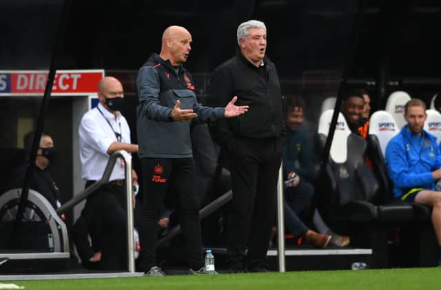 Newcastle manager Steve Bruce (r) with coach Steve Agnew on the touchline during the Premier League match between Newcastle United and Tottenham Hotspur at St. James Park on October 17, 2021 in Newcastle upon Tyne, England.
