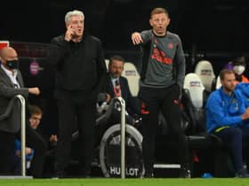 Newcastle manager Steve Bruce (l) with coach Graeme Jones on the touchline during the Premier League match between Newcastle United and Tottenham Hotspur at St. James Park on October 17, 2021 in Newcastle upon Tyne, England.