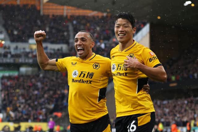 Hwang Hee-chan celebrates with Marcal of Wolverhampton Wanderers after scoring their team’s second goal during the Premier League match between Wolverhampton Wanderers and Newcastle United at Molineux on October 02, 2021 in Wolverhampton, England. 