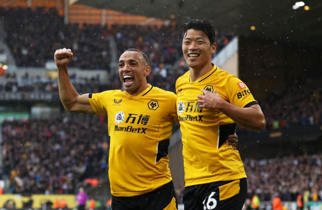 Hwang Hee-chan celebrates with Marcal of Wolverhampton Wanderers after scoring their team’s second goal during the Premier League match between Wolverhampton Wanderers and Newcastle United at Molineux on October 02, 2021 in Wolverhampton, England.
