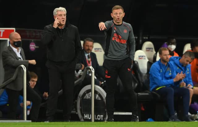 Newcastle manager Steve Bruce (l) with coach Graeme Jones on the touchline during the Premier League match between Newcastle United and Tottenham Hotspur at St. James Park on October 17, 2021 in Newcastle upon Tyne, England.