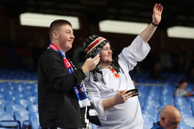 Fans react inside the stadium prior to the Premier League match between Crystal Palace and Newcastle United at Selhurst Park on October 23, 2021 in London, England.