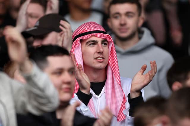 A Newcastle United fan applauds during the Premier League match between Crystal Palace and Newcastle United at Selhurst Park on October 23, 2021 in London, England. 