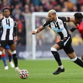 Joelinton of Newcastle United is challenged by Wilfried Zaha of Crystal Palace during the Premier League match between Crystal Palace and Newcastle United at Selhurst Park on October 23, 2021 in London, England. 