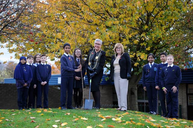 The Mayor of South Tyneside Cllr Pat Hay and Mayoress Mrs Jean Copp help Hadrian Primary School pupils plant a tree.