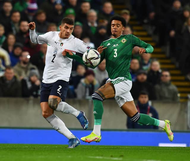 Giovanni Di Lorenzo of Italy competes for the ball with Jamal Lewis of Northem Ireland during the 2022 FIFA World Cup Qualifier match between Northern Ireland and Italy at Windsor Park on November 15, 2021 in Belfast, Northern Ireland. 