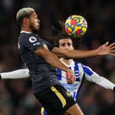 Joelinton of Newcastle United beats Marc Cucurella of Brighton & Hove Albion to the ball during the Premier League match between Brighton & Hove Albion and Newcastle United at American Express Community Stadium on November 06, 2021 in Brighton, England. 