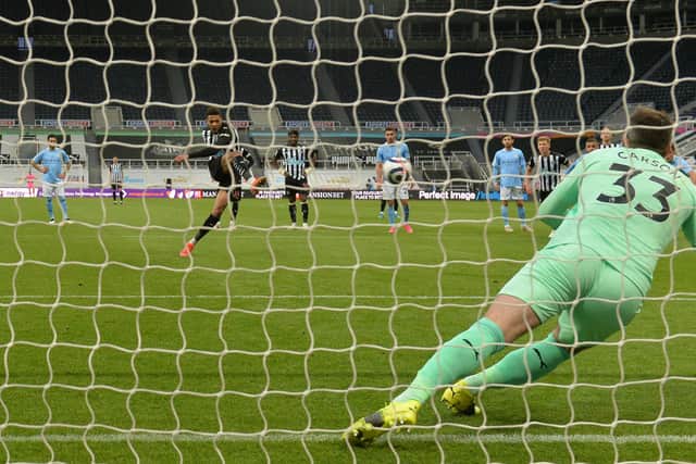 Joelinton of Newcastle United scores their side’s second goal from the penalty spot past Scott Carson of Manchester City during the Premier League match between Newcastle United and Manchester City at St. James Park on May 14, 2021.