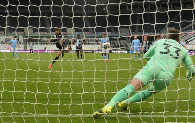 Joelinton of Newcastle United scores their side’s second goal from the penalty spot past Scott Carson of Manchester City during the Premier League match between Newcastle United and Manchester City at St. James Park on May 14, 2021.