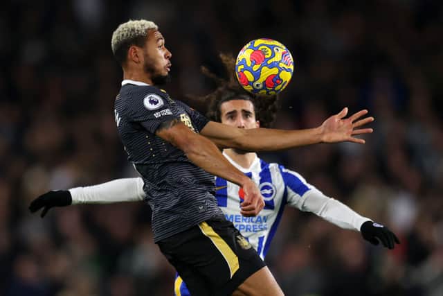 Joelinton of Newcastle United beats Marc Cucurella of Brighton & Hove Albion to the ball during the Premier League match between Brighton & Hove Albion and Newcastle United at American Express Community Stadium on November 06, 2021.