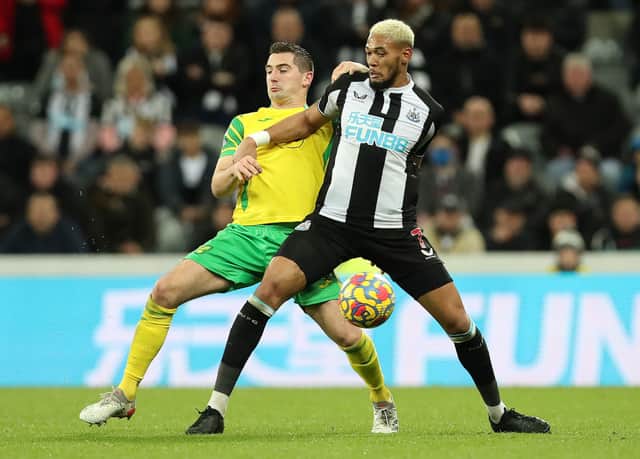 Kenny McLean of Norwich City vies wit Joelinton of Newcastle United during the Premier League match between Newcastle United  and  Norwich City at St. James Park on November 30, 2021.