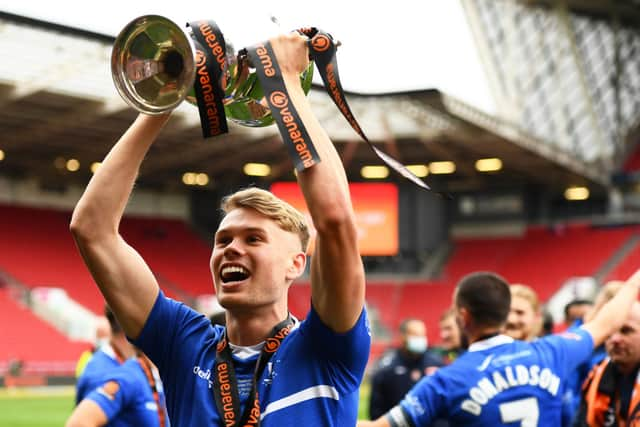 Lewis Cass of Hartlepool United celebrates with the trophy following the Vanarama National League Play-Off Final match between Hartlepool United and Torquay United at Ashton Gate on June 20, 2021 in Bristol, England. 