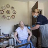A vaccine is administered in a UK care home (Image: Getty Images)