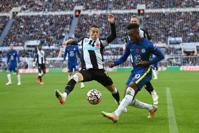 Chelsea winger Callum Huson-Odoi crosses despite the challenge of Javier Manquillo of Newcastle during the Premier League match between Newcastle United and Chelsea at St. James Park on October 30, 2021 in Newcastle upon Tyne, England.