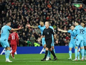 Newcastle United surround referee Mike Dean after protests over Liverpool’s equaliser. 