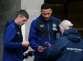 Ciaran Clark and Jamaal Lascelles of Newcastle United have their Covid-19 passes scanned as they arrive at the stadium prior to the Premier League match between Newcastle United and Manchester City at St. James Park on December 19, 2021 in Newcastle upon Tyne, England.
