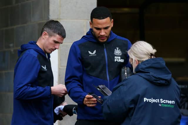 <p>Ciaran Clark and Jamaal Lascelles of Newcastle United have their Covid-19 passes scanned as they arrive at the stadium prior to the Premier League match between Newcastle United and Manchester City at St. James Park on December 19, 2021 in Newcastle upon Tyne, England.</p>