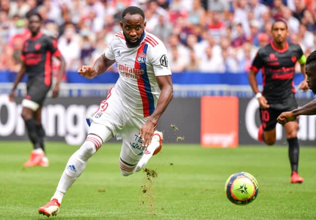Lyon’s French forward Moussa Dembele runs with the ball during the French L1 football match between Olympique Lyonnais and Clermont Foot 63 at the Groupama stadium in Decines-Charpieu near Lyon, central eastern France on August 22, 2021. 
