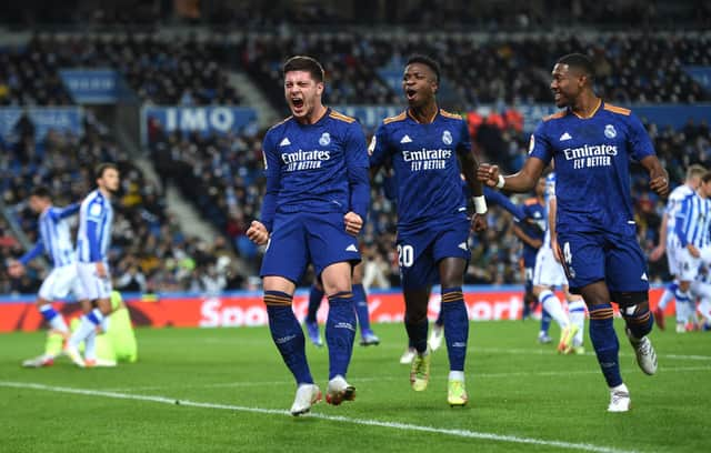 Luka Jovic of Real Madrid celebrates with teammates Vinicius Junior and David Alaba after scoring their side’s second goal during the La Liga Santander match between Real Sociedad and Real Madrid CF at Reale Arena on December 04, 2021 in San Sebastian, Spain. 