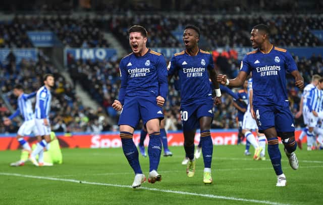 <p>Luka Jovic of Real Madrid celebrates with teammates Vinicius Junior and David Alaba after scoring their side’s second goal during the La Liga Santander match between Real Sociedad and Real Madrid CF at Reale Arena on December 04, 2021 in San Sebastian, Spain. </p>