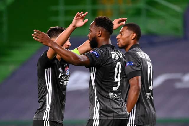 Moussa Dembele of Olympique Lyon celebrates with teammates after scoring his team’s third goal during the UEFA Champions League Quarter Final match between Manchester City and Lyon at Estadio Jose Alvalade on August 15, 2020 in Lisbon, Portugal.