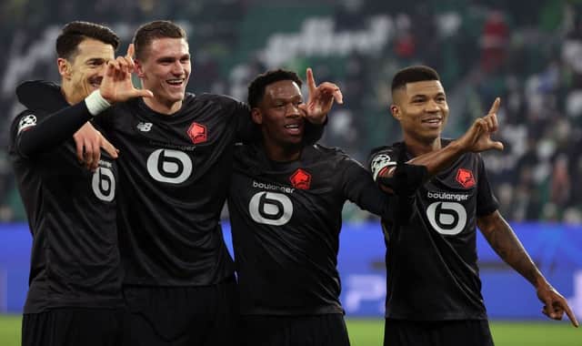 (L-R) Lille’s Portuguese defender Jose Fonte, Lille’s Dutch defender Sven Botman, Lille’s Canadian forward Jonathan David and Lille’s Mozambican defender Reinildo Mandava celebrate scoring during the UEFA Champions League group G football match VfL Wolfsburg v Lille LOSC in Wolfsburg, northern Germany on December 8, 2021. 