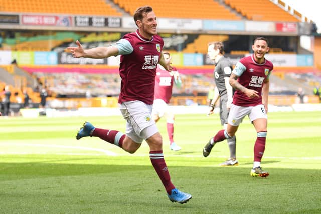 Chris Wood of Burnley celebrates after scoring their side’s third goal and his hat trick during the Premier League match between Wolverhampton Wanderers and Burnley at Molineux on April 25, 2021 in Wolverhampton, England.