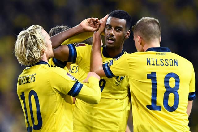 Sweden’s forward Alexander Isak (C) celebrates scoring his team’s first goal with his team mates during the FIFA World Cup Qatar 2022 qualification Group B football match between Sweden and Kosovo at the Friends Arena in Solna, Sweden, on October 9, 2021.
