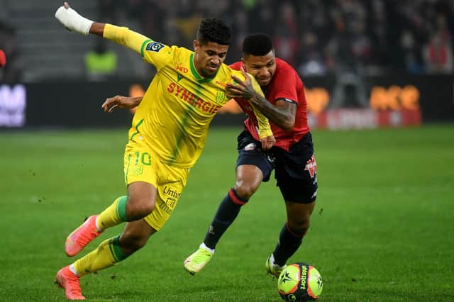 Nantes' French midfielder Ludovic Blas (L) is challenged by Lille's Mozambican defender Reinildo during the French L1 football match between Lille LOSC and FC Nantes at the Pierre-Mauroy stadium in Villeneuve-d'Ascq, near Lille, northern France on November 27, 2021