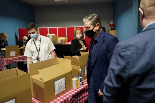 Labour leader Keir Starmer packs Christmas food hampers as he visits Hadston House youth and community projects in Northumberland to meet people affected by Storm Arwen on December 10, 2021