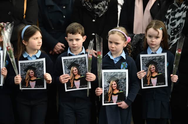 Pupils from Ashling Murphy’s class hold photographs of her and red roses ahead of her funeral at St. Brigidâs Church (Image: Getty Images)