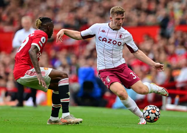 <p>Manchester United's French defender Raphael Varane (L) vies with Aston Villa's English defender Matt Targett during the English Premier League football match between Manchester United and Aston Villa at Old Trafford</p>