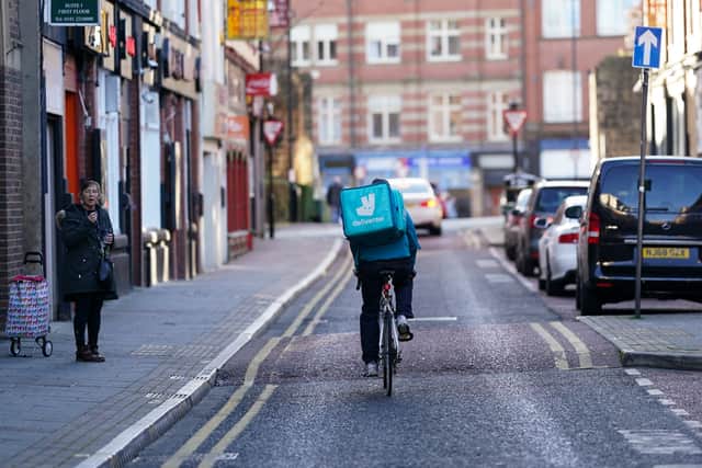 A delivery driver rides through Newcastle’s Chinatown (Image: Getty Images)