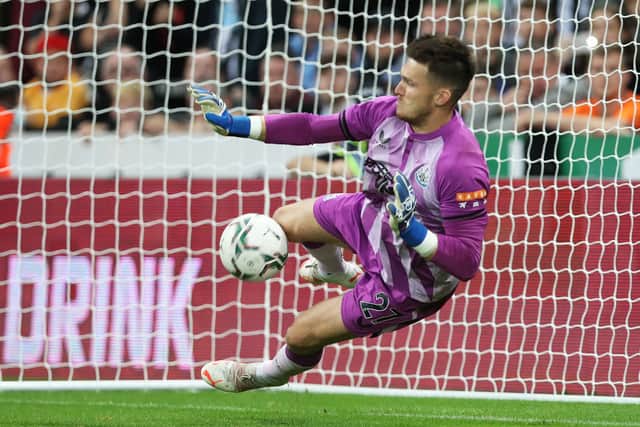 Freddie Woodman of Newcastle United saves a penalty in the shootout during the Carabao Cup Second Round match between Newcastle United and Burnley at St. James Park on August 25, 2021 in Newcastle upon Tyne, England. 