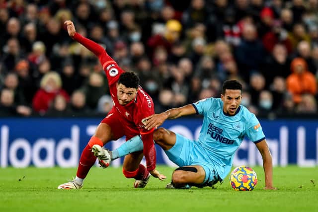 Alex Oxlade-Chamberlain of Liverpool competing with Isaac Hayden of Newcastle United during the Premier League match between Liverpool and Newcastle United at Anfield on December 16, 2021 in Liverpool, England. 