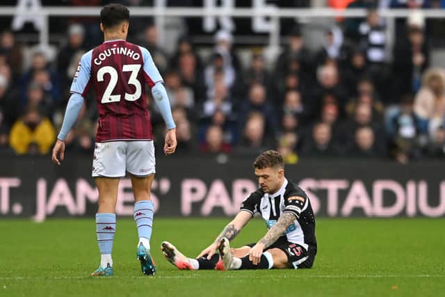 Newcastle full back Kieran Trippier sits down on the turf before leaving the field with an injury during the Premier League match between Newcastle United and Aston Villa at St. James Park on February 13, 2022 in Newcastle upon Tyne, England. 