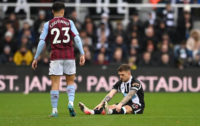 Newcastle full back Kieran Trippier sits down on the turf before leaving the field with an injury during the Premier League match between Newcastle United and Aston Villa at St. James Park on February 13, 2022 in Newcastle upon Tyne, England.