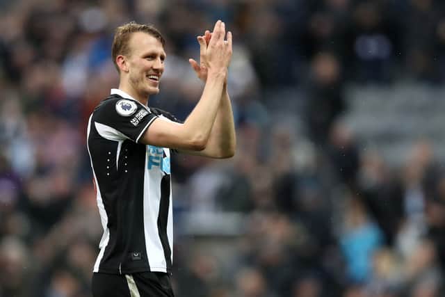 Dan Burn of Newcastle United applauds the fans following victory in the Premier League match between Newcastle United and Aston Villa at St. James Park on February 13, 2022 in Newcastle upon Tyne, England.