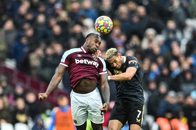 Michail Antonio challenges Joelinton for the ball