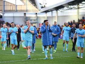 Matt Targett and Joe Willock of Newcastle United applauds fans after their sides victory during the Premier League match between Brentford and Newcastle United at Brentford Community Stadium