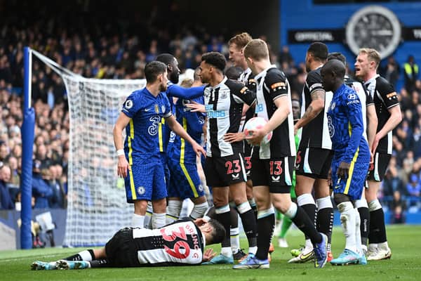 LONDON, ENGLAND - MARCH 13: Players of Chelsea and Newcastle United interact as Bruno Guimaraes of Newcastle United is injured during the Premier League match between Chelsea and Newcastle United at Stamford Bridge on March 13, 2022 in London, England. (Photo by Clive Mason/Getty Images)