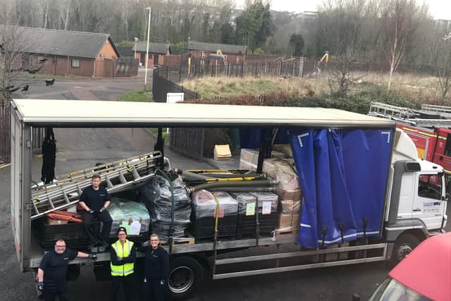 Staff at Tony Carter Transport Limited loading fire equipment onto lorry at TWFRS Stores warehouse (Image: TWFRS)