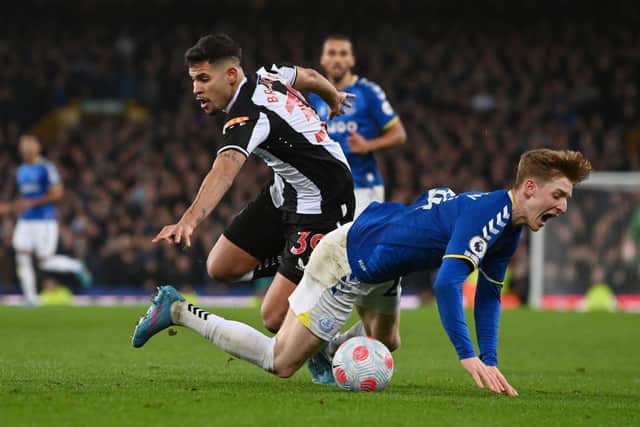 Anthony Gordon of Everton reacts after being challenged by Bruno Guimaraes of Newcastle United during the Premier League match between Everton and Newcastle United at Goodison Park on March 17, 2022 in Liverpool, England.
