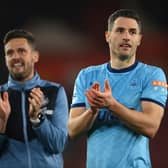 Fabian Schar of Newcastle United (R) and assistant head coach Jason Tindall applaud the travelling fans at the end of the Premier League match between Southampton and Newcastle United at St Mary’s Stadium on March 10, 2022 in Southampton, England.  