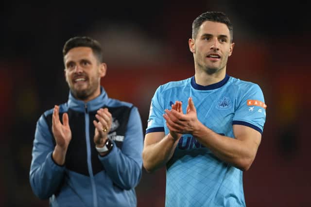 <p>Fabian Schar of Newcastle United (R) and assistant head coach Jason Tindall applaud the travelling fans at the end of the Premier League match between Southampton and Newcastle United at St Mary’s Stadium on March 10, 2022 in Southampton, England.  </p>