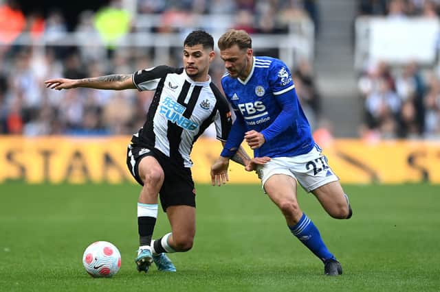 Bruno Guimaraes of Newcastle United is challenged by Kiernan Dewsbury-Hall of Leicester City during the Premier League match between Newcastle United and Leicester City at St. James Park on April 17, 2022 in Newcastle upon Tyne, England. 