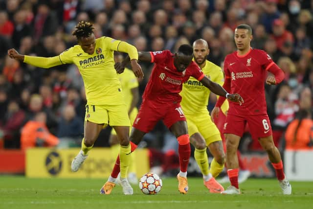 Samuel Chukwueze of Villarreal CF battles for possession with Sadio Mane of Liverpool during the UEFA Champions League Semi Final Leg One match between Liverpool and Villarreal at Anfield on April 27, 2022 in Liverpool, England.