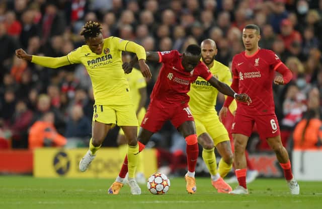 Samuel Chukwueze of Villarreal CF battles for possession with Sadio Mane of Liverpool during the UEFA Champions League Semi Final Leg One match between Liverpool and Villarreal at Anfield on April 27, 2022 in Liverpool, England.