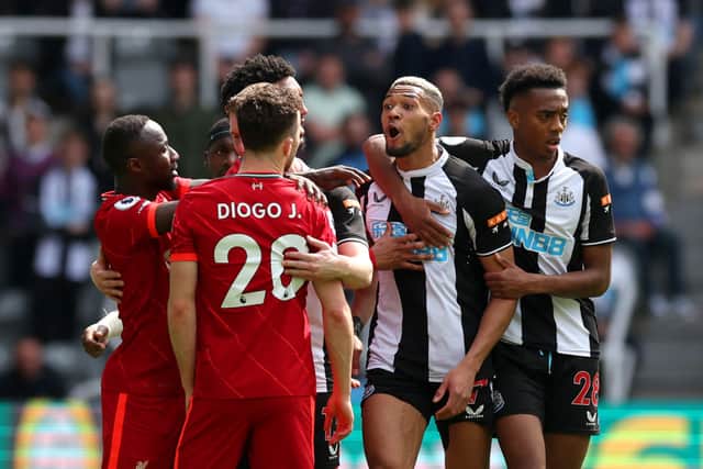 Joelinton of Newcastle United clashes with Diogo Jota of Liverpool during the Premier League match between Newcastle United and Liverpool at St. James Park on April 30, 2022 in Newcastle upon Tyne, England.